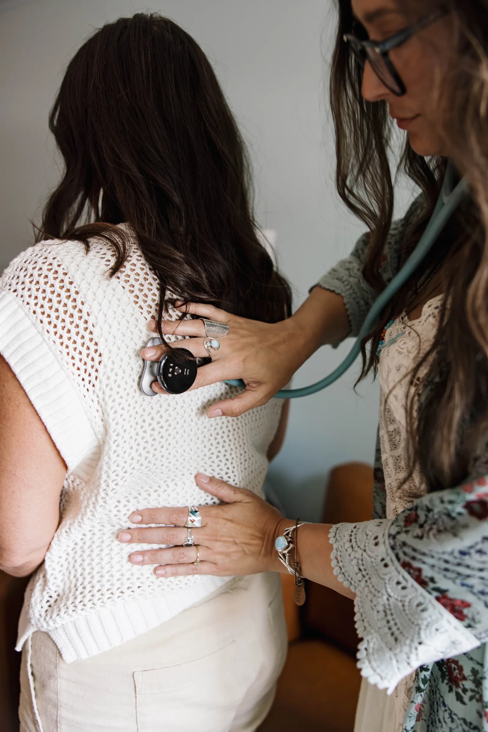 Alley Tuttle listening to a person’s lungs with a stethoscope