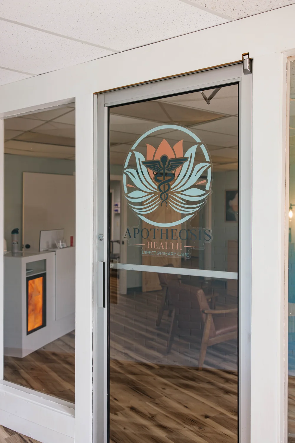The glass entrance to Apotheosis Health in Bangor, Maine
