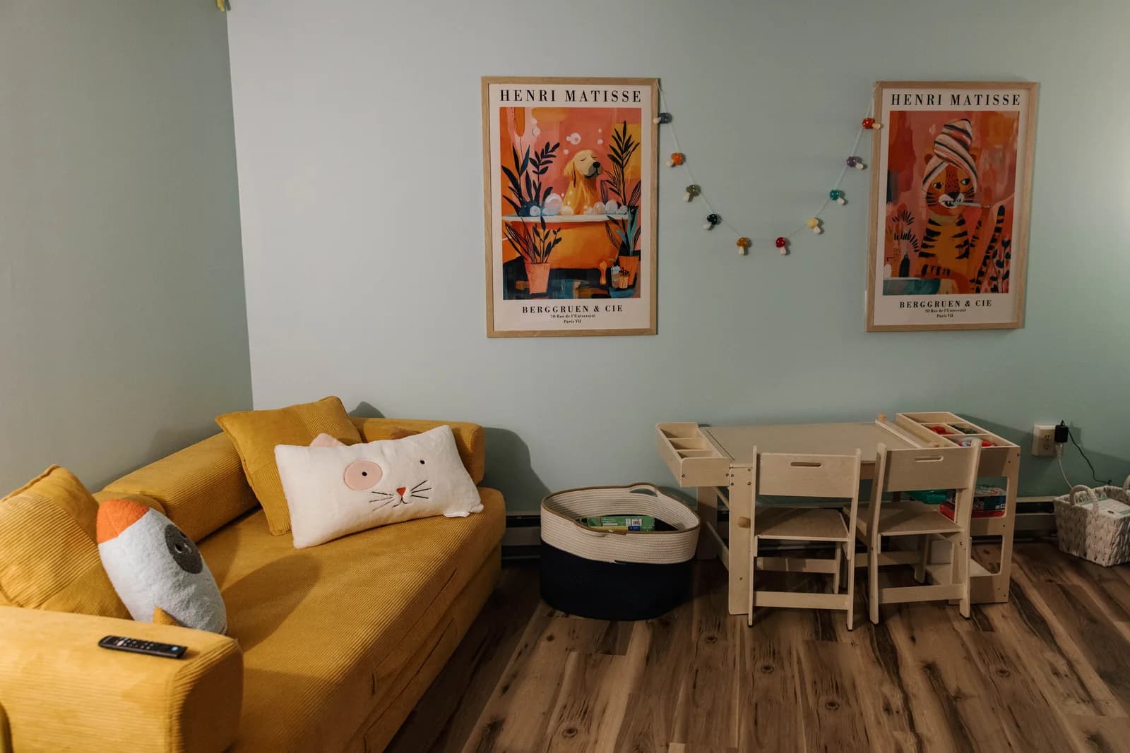 Children’s room at Apotheosis Health with a yellow sofa, books, and activity tables