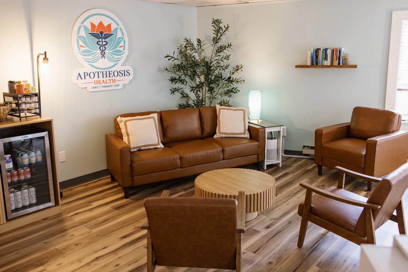 The reception room at Apotheosis Health, with leather seating and the practice logo