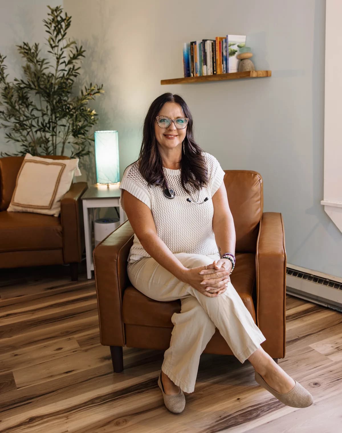 Heather seated in a bright room at Apotheosis Health