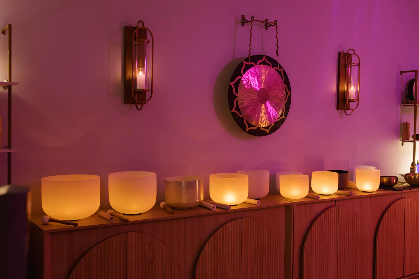 Singing bowls arranged beneath a gong in the Your Essence sound room